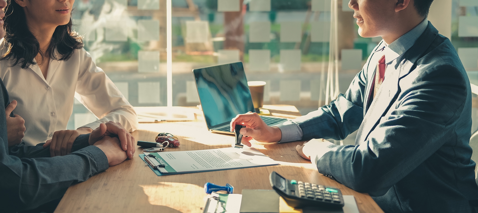 couple talking with a banker over paper work